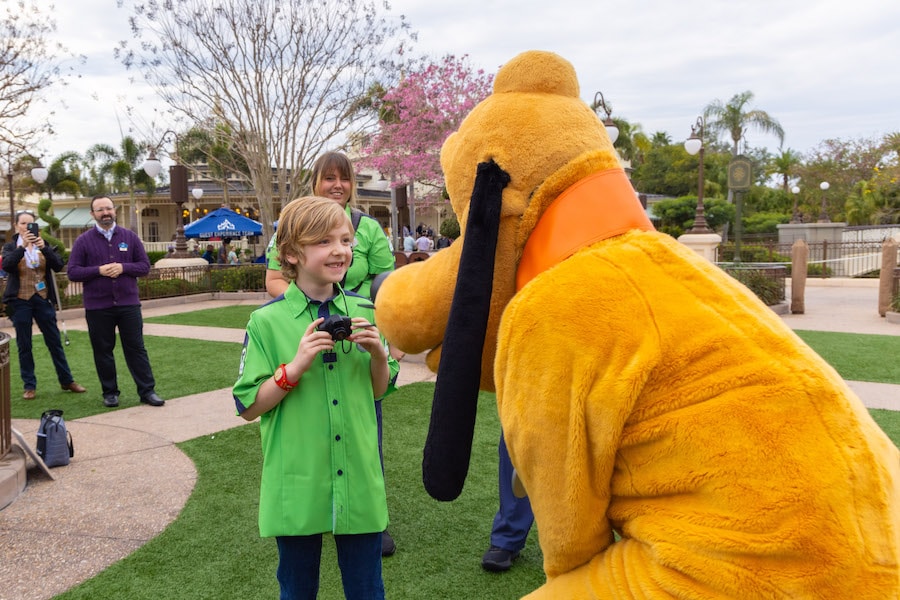 Image of child dressed as Disney PhotoPass cast member with Pluto