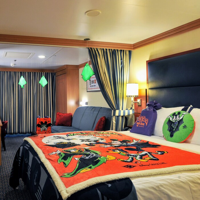 A Disney Cruise Line stateroom decorated with Halloween themed mobiles, bedding and gifts
